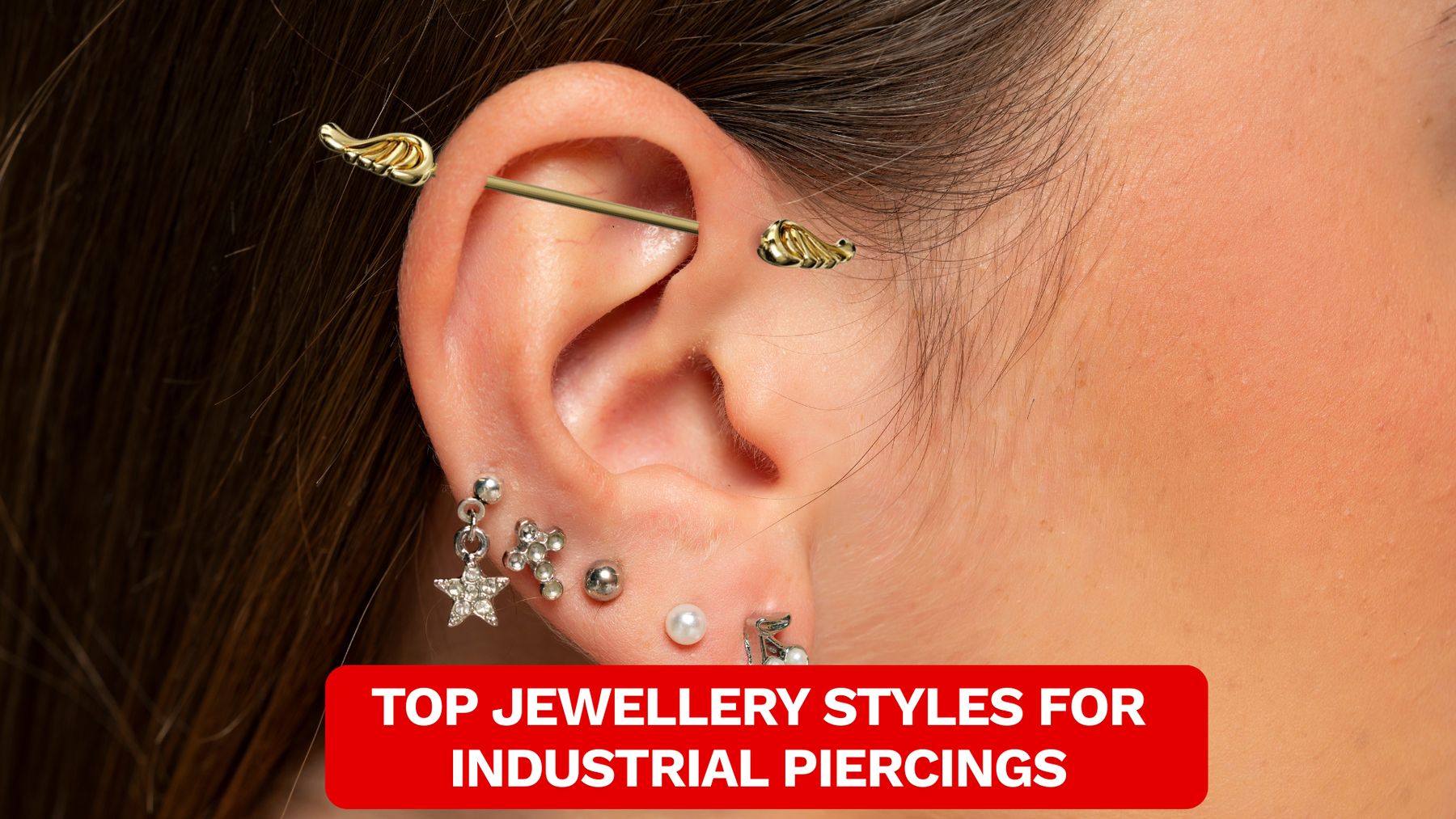 Image of a female wearing gold industrial piercing that has designed ends