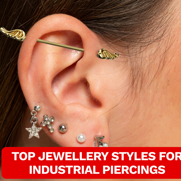 Image of a female wearing gold industrial piercing that has designed ends