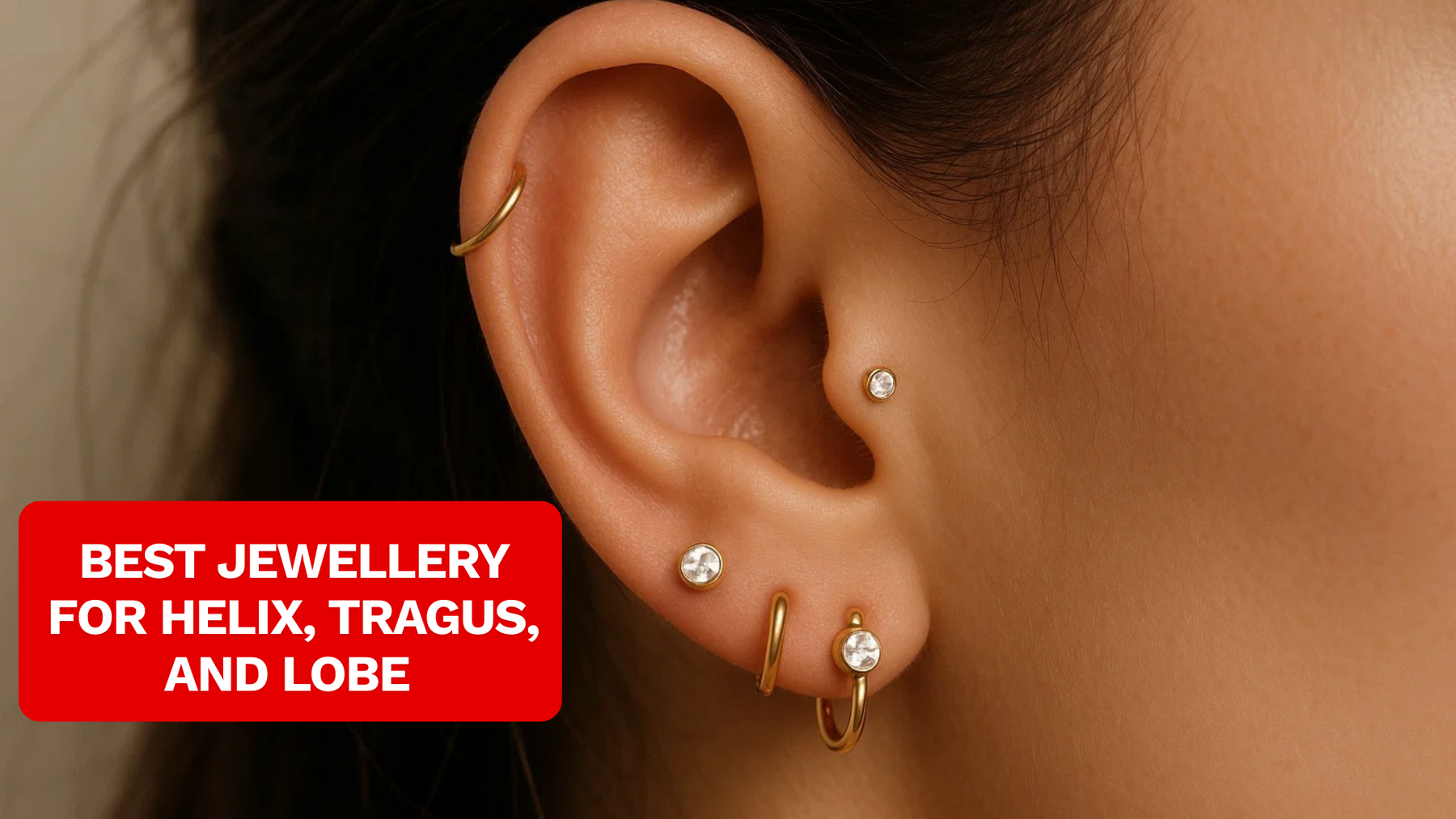 close up of female model wearing helix piercing, tragus piercing and lobe piercings
