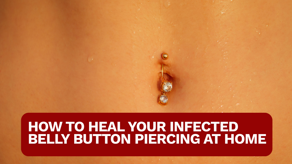 CLOSE UP OF A BELLY WITH DANGLING GOLD BELLY PIERCING