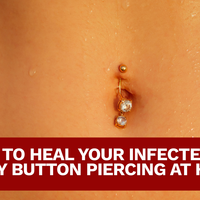 CLOSE UP OF A BELLY WITH DANGLING GOLD BELLY PIERCING