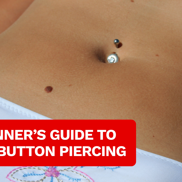 close up of a belly with belly piercing jewellery