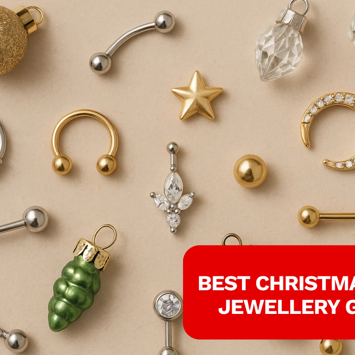 A display of multiple piercing jewelry like flat back, septum hoops on a surface