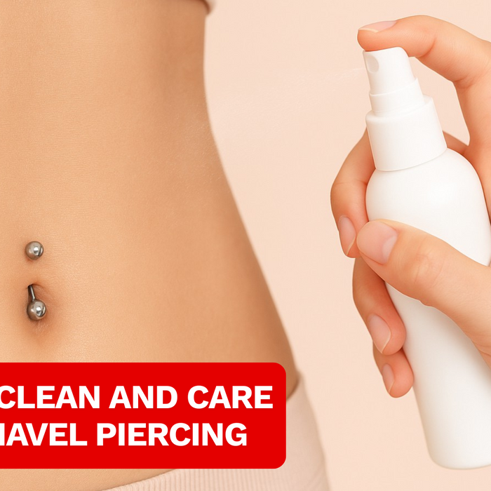 close up of a female belly wearing belly bar and sprying saline solution on it