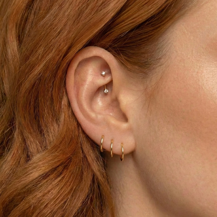 Gold segment clicker ear ring with a hinged design