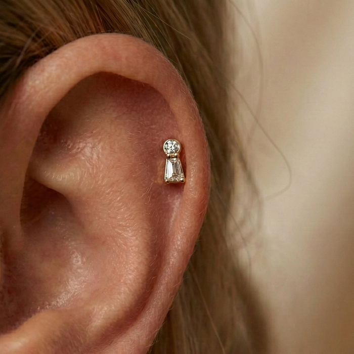 Gold and silver CZ threadless flatback stud in cartilage piercing