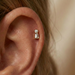 Gold and silver CZ threadless flatback stud in cartilage piercing