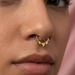Model wearing gold heart septum clicker